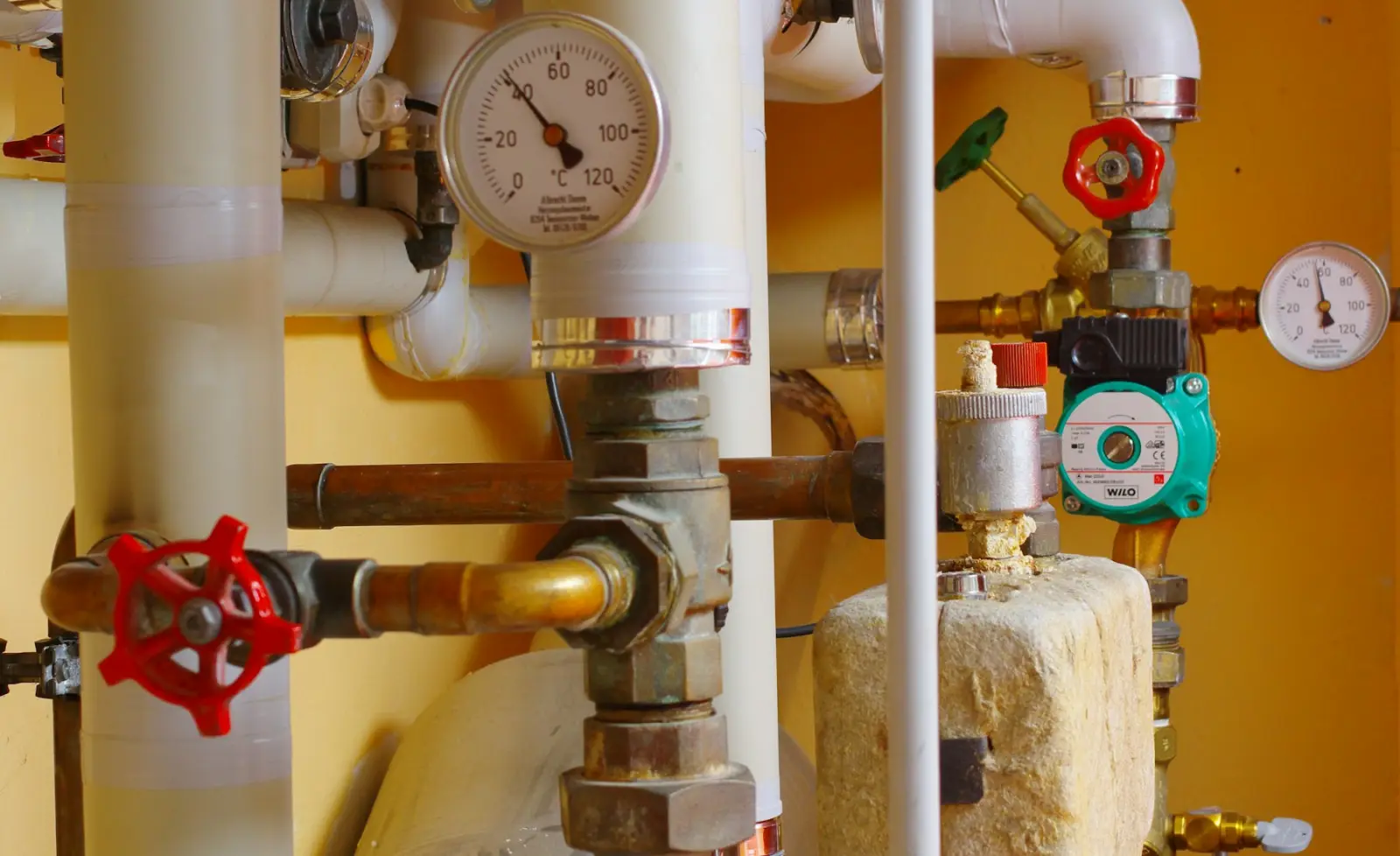 Pipework, a circulating pump and gauges in a plant room
