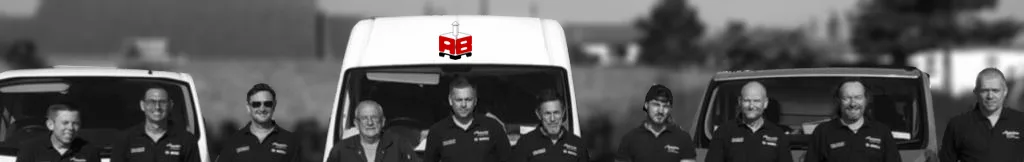 The Anglia Boiler Maintenance team standing in front of the company vans
